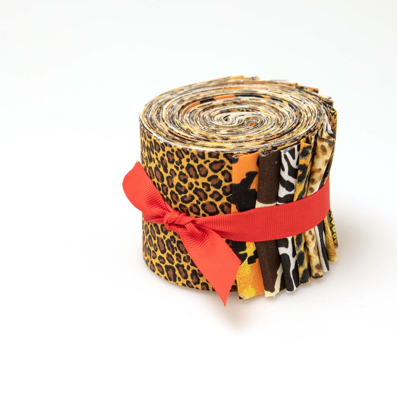 May include: A roll of fabric featuring a variety of animal print designs, including leopard, zebra, and cheetah. The fabric is tied with a red ribbon.