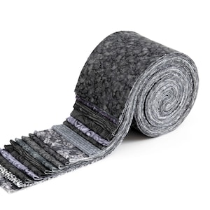 May include: A rolled bundle of fabric strips in various shades of gray and black. The fabric has different patterns, including floral and textured designs. The roll is on a white background.