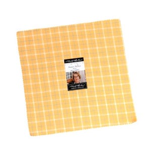 May include: A square stack of fabric squares in a yellow plaid pattern. The fabric has a grid of white and light blue lines. A label in the center reads "moda Summer Solstice" and features a photo of a woman.