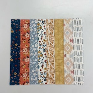 May include: Eight fabric strips with different patterns. The strips are in a variety of colors, including blue, orange, yellow, and white. The patterns include floral, geometric, and abstract designs.