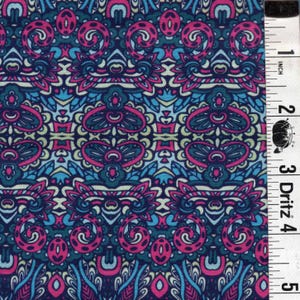 May include: Close-up of a fabric with a repeating pattern in shades of blue, pink, and teal. The design includes floral and abstract shapes. A ruler with inch measurements is on the right side of the fabric.