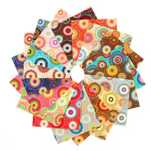 May include: A collection of 24 fabric squares with a colorful, circular pattern. The squares are arranged in a circle, with the center of the circle being a white background. The fabric squares are all different colors, including red, orange, yellow, green, blue, purple, and brown. The circular pattern on the fabric squares is made up of small circles and dots.