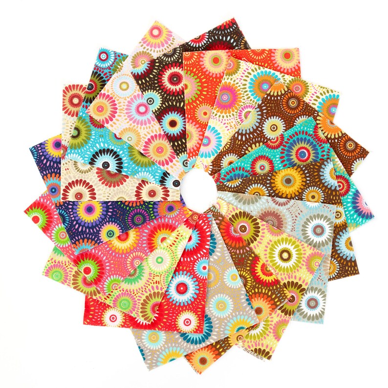 May include: A collection of 24 fabric squares with a colorful, circular pattern. The squares are arranged in a circle, with the center of the circle being a white background. The fabric squares are all different colors, including red, orange, yellow, green, blue, purple, and brown. The circular pattern on the fabric squares is made up of small circles and dots.