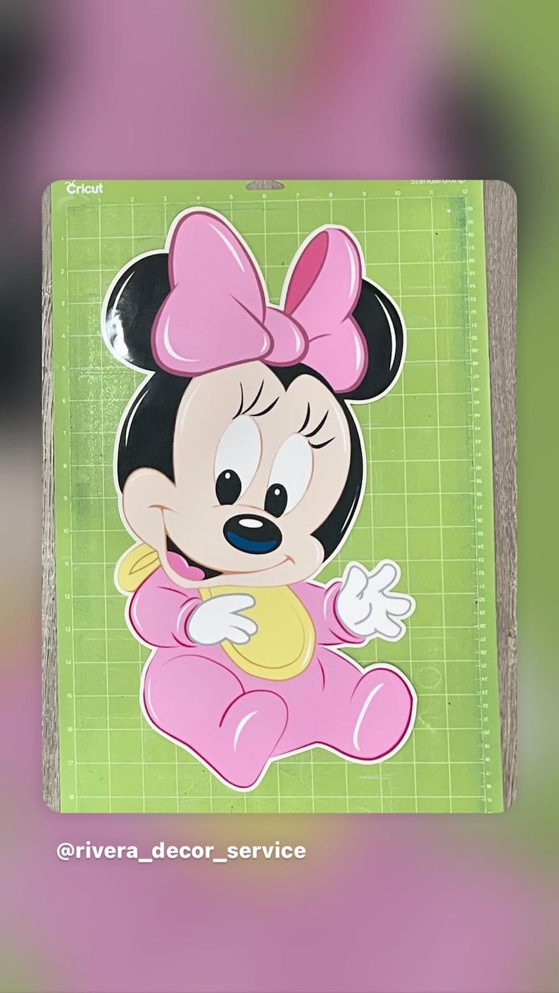 May include: A pink Minnie Mouse cutout, featuring a large bow, black ears, and a yellow bib. The character is seated on a green cutting mat. The Cricut logo is visible in the top left corner. The Instagram handle @rivera_decor_service is at the bottom.