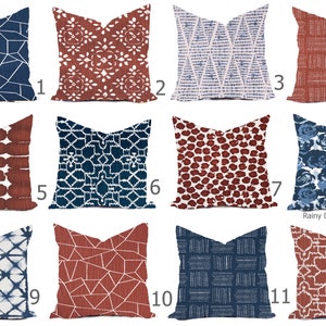 May include: Twelve different pillow designs with geometric patterns in shades of blue, red, and white. The pillows are arranged in four rows of three. The text "Rainy Day Divine, LLC" is visible in the bottom right corner.