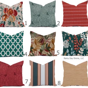 Pode incluir: Nove almofadas decorativas com vários padrões. As almofadas incluem desenhos florais, geométricos e listrados em cores como vermelho, verde-azulado e bege. As almofadas são quadradas e feitas de tecido.