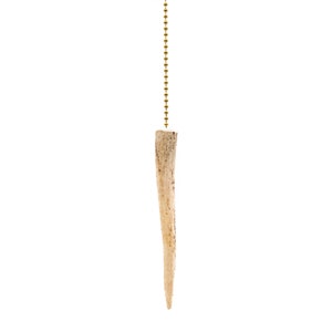 May include: A light brown antler pull chain for a ceiling fan or light fixture. The antler is attached to a gold chain.