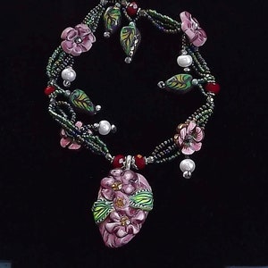 Beaded flowered necklace, Fantasy,Fairy Like pendant necklace, Pink, green, and Reds with pearls and crystals.25&quot;