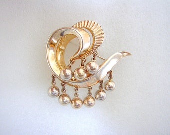 TRIFARI Crown  - Retro swirl brooch with ball dangles solid metal with gold wash Mid-1950s