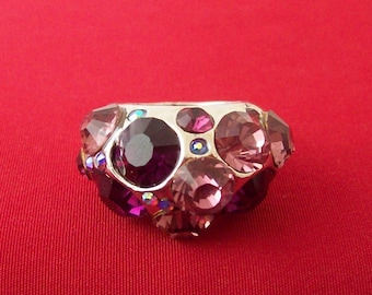 Domed silver plated metal ring encrusted with purple, pink and clear AB rhinestones