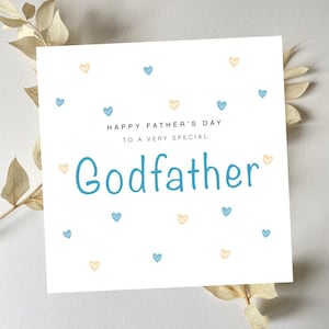 May include: White card with blue and yellow hearts scattered across the surface. The card reads "Happy Father's Day to a very special Godfather".