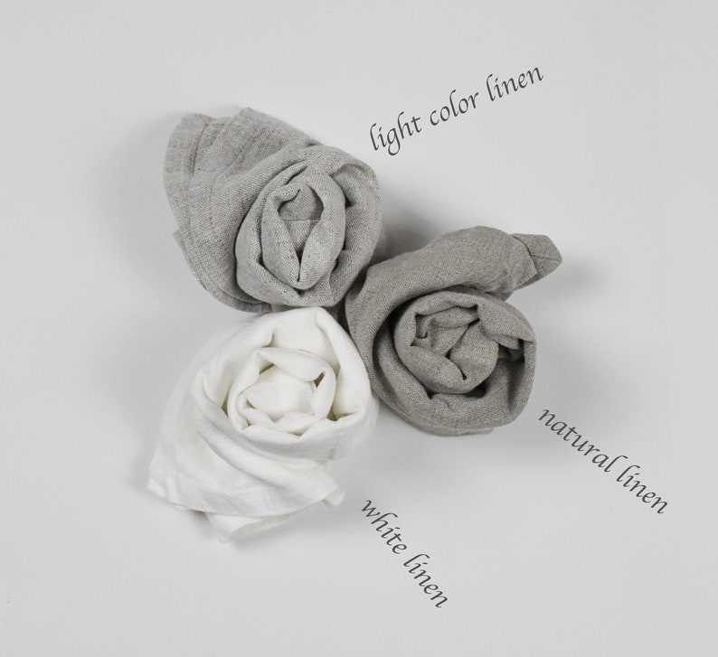 May include: Three rolls of linen fabric in different shades of gray. The rolls are labeled "light color linen", "natural linen", and "white linen".