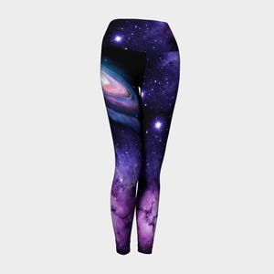 May include: Purple and black leggings with a galaxy print featuring a swirling nebula and stars.