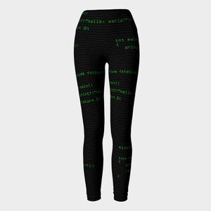 May include: Black leggings with a green code print. The code includes the text "hello world!" and "int main".