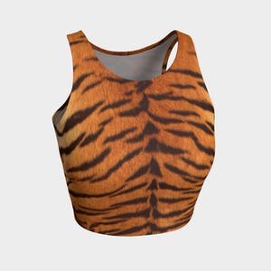 May include: A cropped tank top with a tiger print pattern. The top is sleeveless and has a scoop neck.