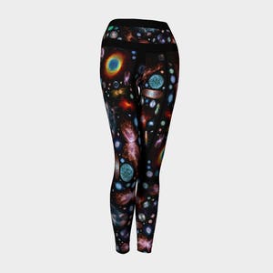 May include: Black leggings with a colorful galaxy print featuring stars, planets, and nebulae.