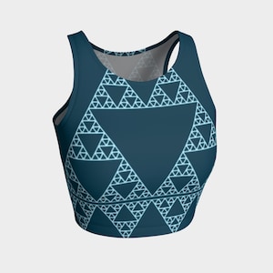 May include: A dark blue crop top with a white geometric pattern of triangles. The pattern is a fractal design.