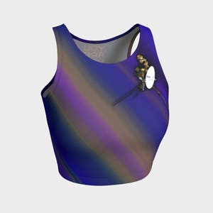 May include: A blue crop top with a gradient design featuring shades of purple, brown, and yellow. A small satellite is printed on the front of the top.