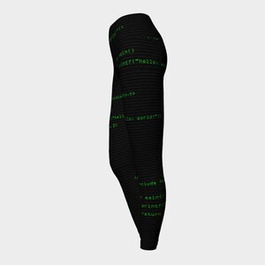 May include: Black leggings with a green code print. The code includes the text "int("hello world!")".