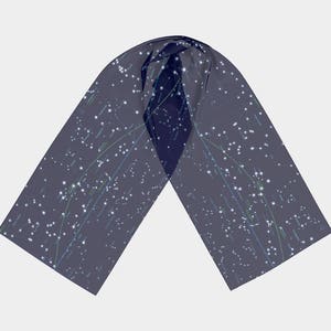 May include: A dark blue scarf with a white constellation pattern. The scarf is made of a soft, lightweight fabric and is perfect for adding a touch of style to any outfit.