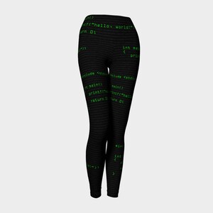 May include: Black leggings with a green code print. The code includes the text "hello world!" and "return 0;"