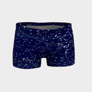 May include: Navy blue athletic shorts with a constellation print. The print features white stars and constellations with their names in light blue.