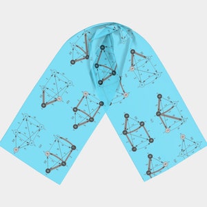 May include: A light blue scarf with a repeating pattern of black and gray graphs with numbers and arrows. The graphs are on a light blue background.