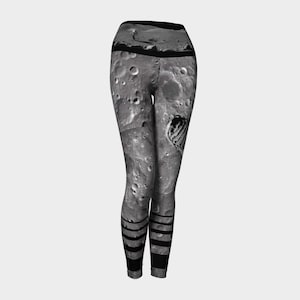 May include: Black and white leggings with a moon surface print and black stripes at the bottom.