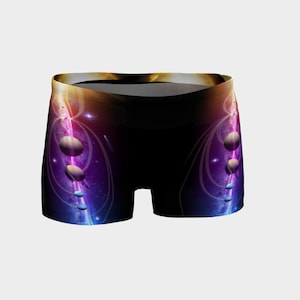 May include: Black athletic shorts with a galaxy print featuring planets and stars in shades of purple, blue, and gold.