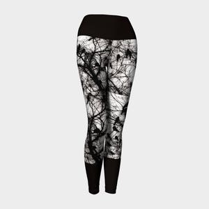 May include: Black and white yoga leggings with a silhouette pattern of birds and branches.