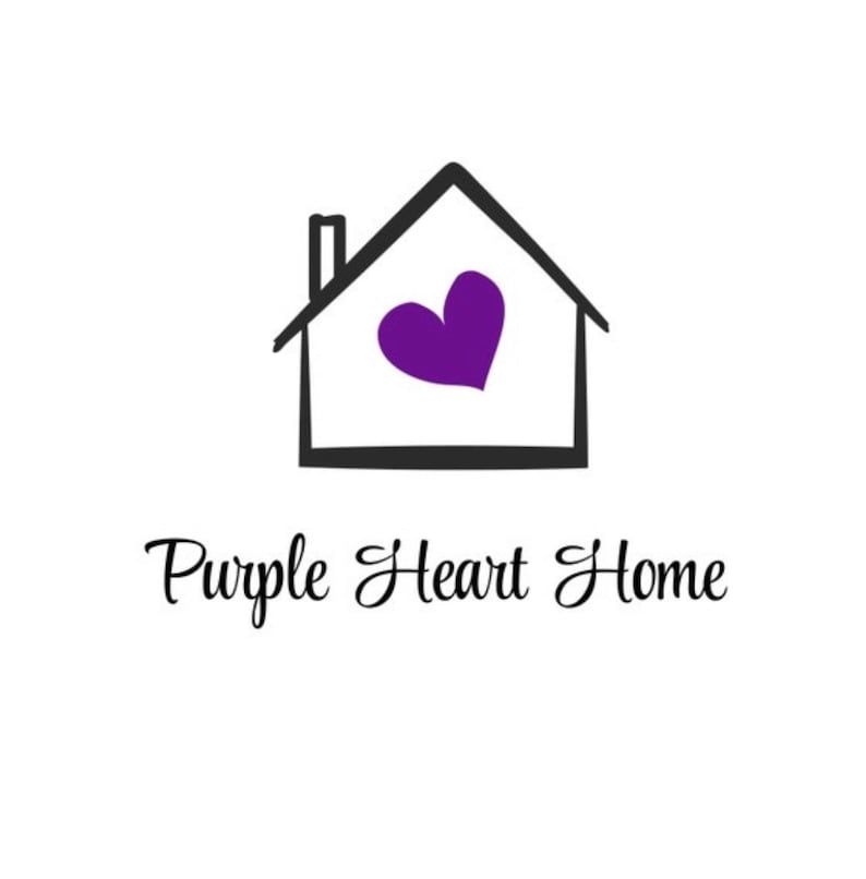 May include: A logo featuring a black outline of a house with a chimney and a solid purple heart shape centered inside. Below the house graphic, the text Purple Heart Home is written in a black, cursive, script-style font on a white background.