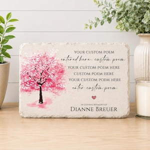 May include: A rectangular stone plaque with a rough, chiseled edge featuring a printed pink cherry blossom tree on the left. The text reads: YOUR CUSTOM POEM entered here, custom poem YOUR CUSTOM POEM HERE CUSTOM POEM HERE YOUR CUSTOM POEM HERE enter custom poem, a small pink heart, and IN LOVING MEMORY OF DIANNE BREUER.