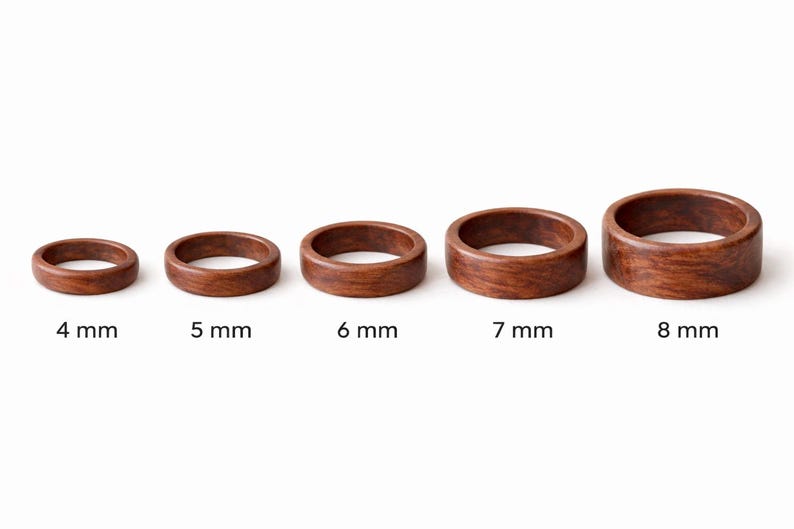 May include: Five wooden rings of varying sizes, each with a rich brown color and visible wood grain. The rings are labeled with their widths: 4 mm, 5 mm, 6 mm, 7 mm, and 8 mm. The rings are displayed against a white background.