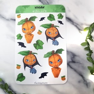 May include: A sheet of Halloween themed stickers featuring a cartoon pumpkin character with fangs and a cape. The stickers are on a white background with green leaves and bats.