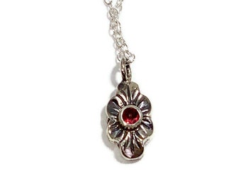 Petit silver and garnet charm pendant great for layering pendants for the fashion conscious woman or girl.