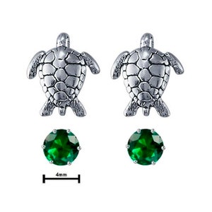 May include: Sterling silver earrings featuring a turtle design with a 4mm round green gemstone.
