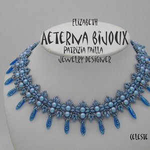 May include: A blue beaded necklace with a flower design and a pendant. The necklace is on a white mannequin bust. The text "AETERNA BIJOUX" is written on the bust. The text "ELIZABETH PATRIZIA FAILLA JEWELRY DESIGNER" is written on the bust. The text "(CELESTE" is written on the bust.