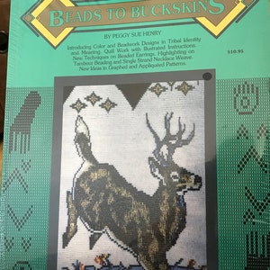 May include: A book titled "Beads to Buckskins, Volume Six" by Peggy Sue Henry. The cover shows a cross-stitch design of a deer leaping over a landscape. The book introduces colour and beadwork designs, techniques on beaded earrings, and more.