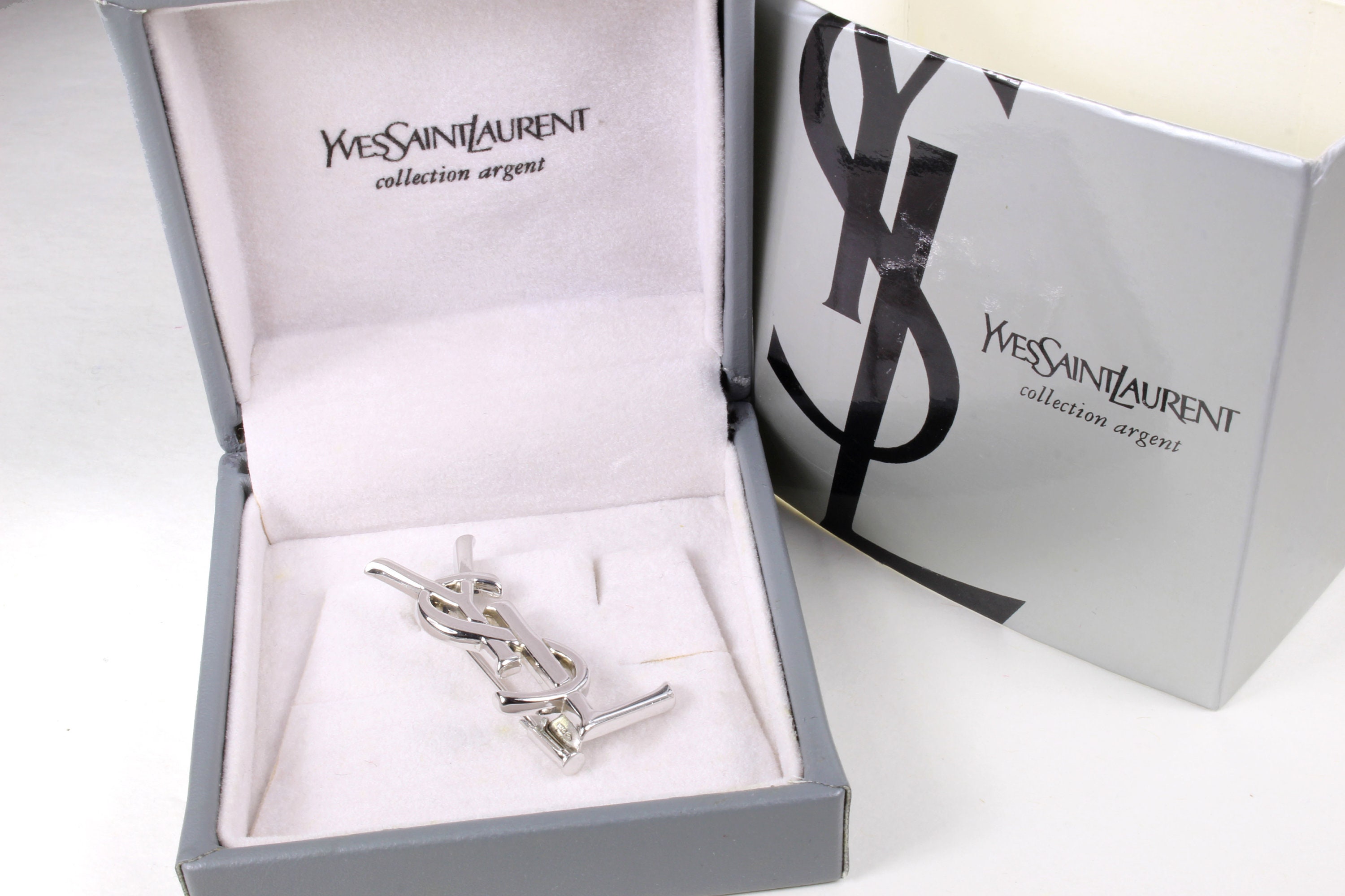 Yves Saint Laurent YSL Logo Brooch (Silver)  Rent Yves Saint Laurent  jewelry for $55/month