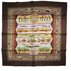 May include: A brown silk scarf with a colorful design featuring stylized figures, boats, and geometric patterns. The design is framed by a border of brown, orange, and white.