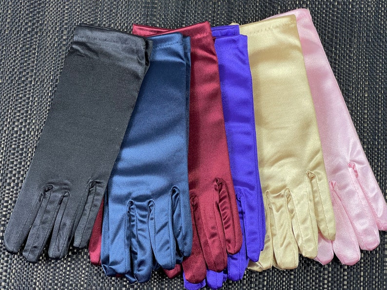 May include: Six pairs of long satin gloves in different colors: black, navy blue, burgundy, purple, beige, and pink.