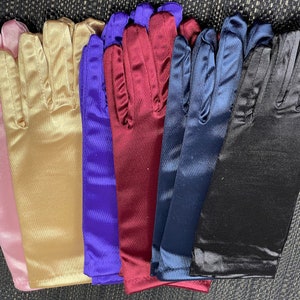 May include: Six pairs of long satin gloves in different colors: pink, gold, purple, burgundy, navy blue, and black.