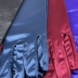 May include: Four pairs of long satin gloves in black, navy blue, burgundy, and royal blue.