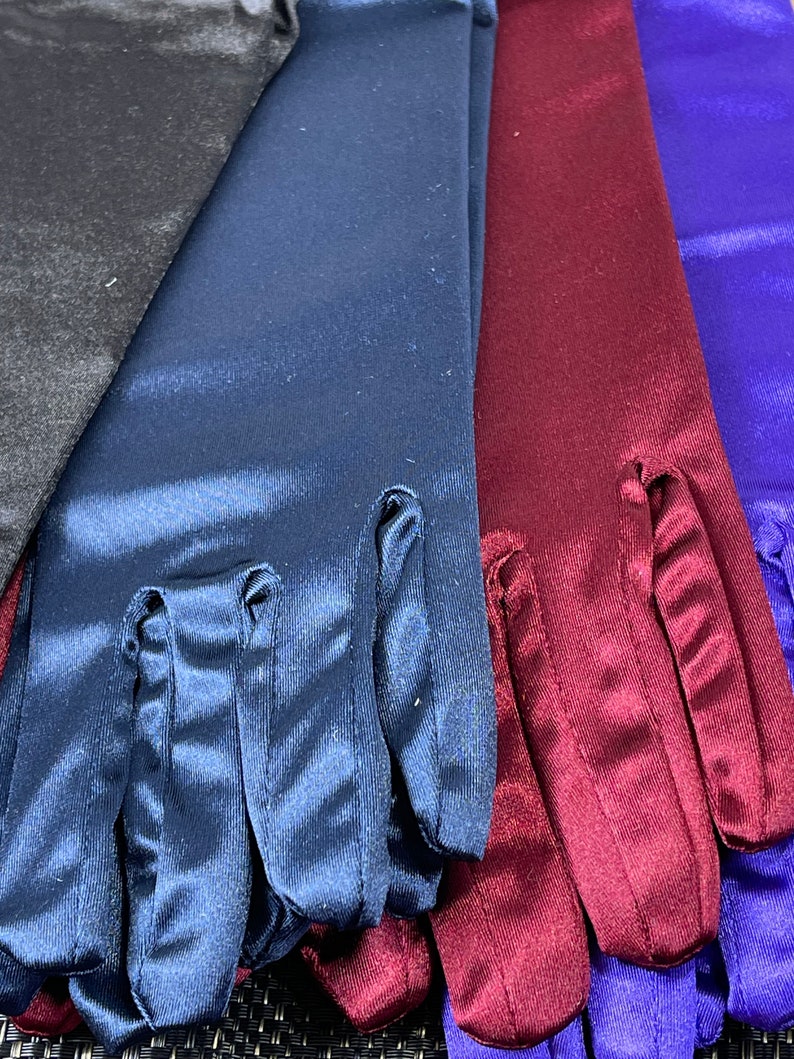 May include: Four pairs of long satin gloves in black, navy blue, burgundy, and royal blue.
