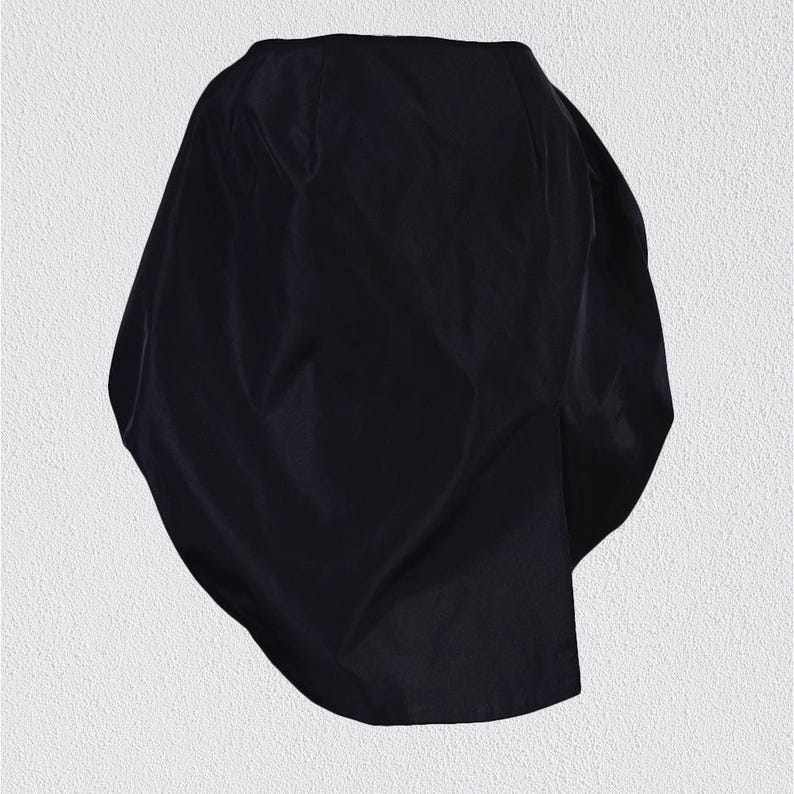 May include: A black, asymmetrical,  fabric skirt with a smooth, silky texture.