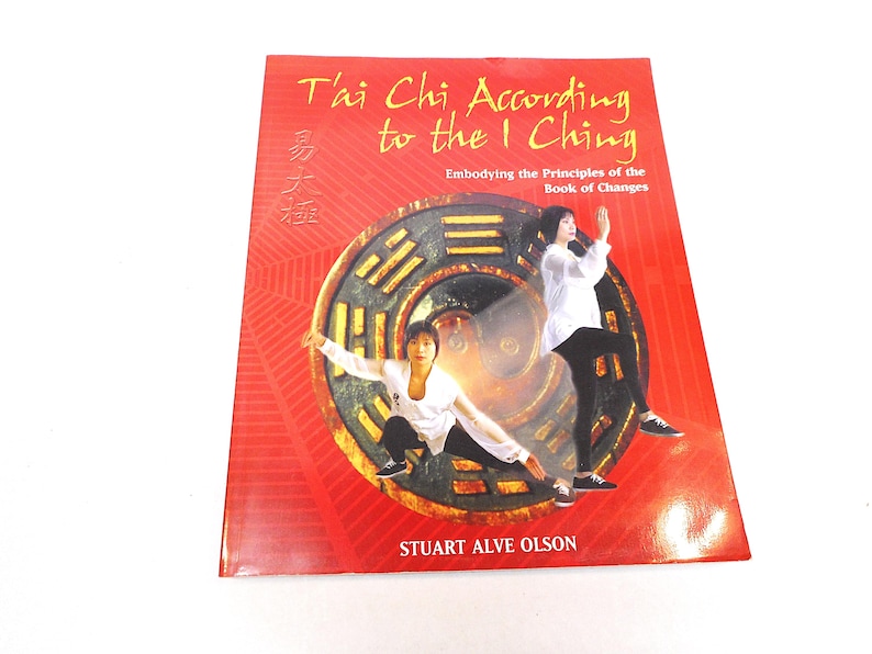 May include: A book titled "Tai Chi According to the I Ching" with the text "Embodying the Principles of the Book of Changes." The cover features images of people practicing Tai Chi and a circular design.