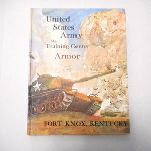 May include: Vintage book cover titled "United States Army Training Center Armor" featuring a painted illustration of a military tank. The cover has a tan background with text and a tank illustration. The text includes "Fort Knox, Kentucky".