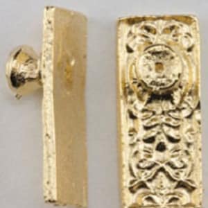 May include: Two pairs of gold-toned door knobs with a decorative, ornate design. Each knob has a flat, rectangular backplate and a round, protruding knob.