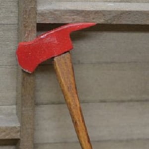 May include: A red and wooden firefighter's axe with a curved handle.