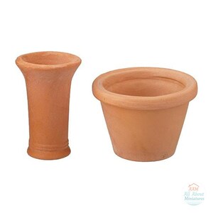 Pode incluir: Um vaso de terracota em miniatura com borda alargada e um vaso de terracota largo a condizer. Ambos os itens apresentam um acabamento em argila natural e um design simples e sem adornos. Um pequeno logótipo com o texto AAM All About Miniatures é visível.